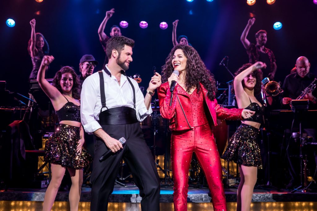 Mauricio Martinez as Emilio Estefan and Christie Prades as Gloria Estefan and the company of the Broadway On Tour presentation of ON YOUR FEET! Oct. 30 – Nov. 4, 2018 at the Sacramento Community Center Theater. Photo by Matthew Murphy.