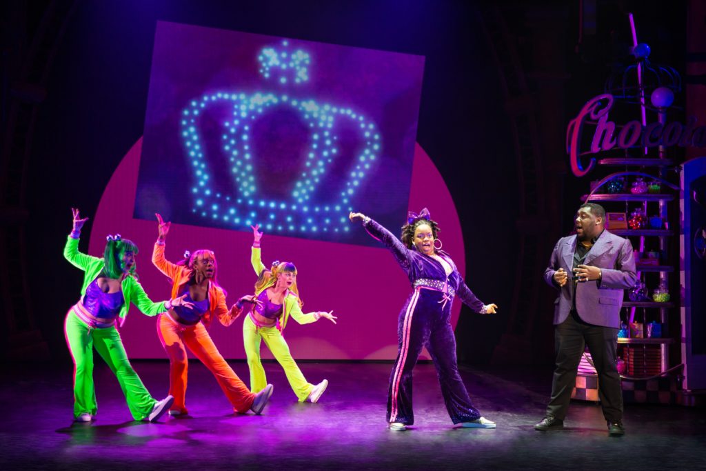 Zakiya Baptiste as Violet Beauregarde, Branden R. Mangan as Mr. Beauregarde, and the Company of Roald Dahl’s CHARLIE AND THE CHOCOLATE FACTORY presented by Broadway On Tour December 28, 2021 – January 2, 2022 at the SAFE Credit Union Performing Arts Center. Photo by Jeremy Daniel.