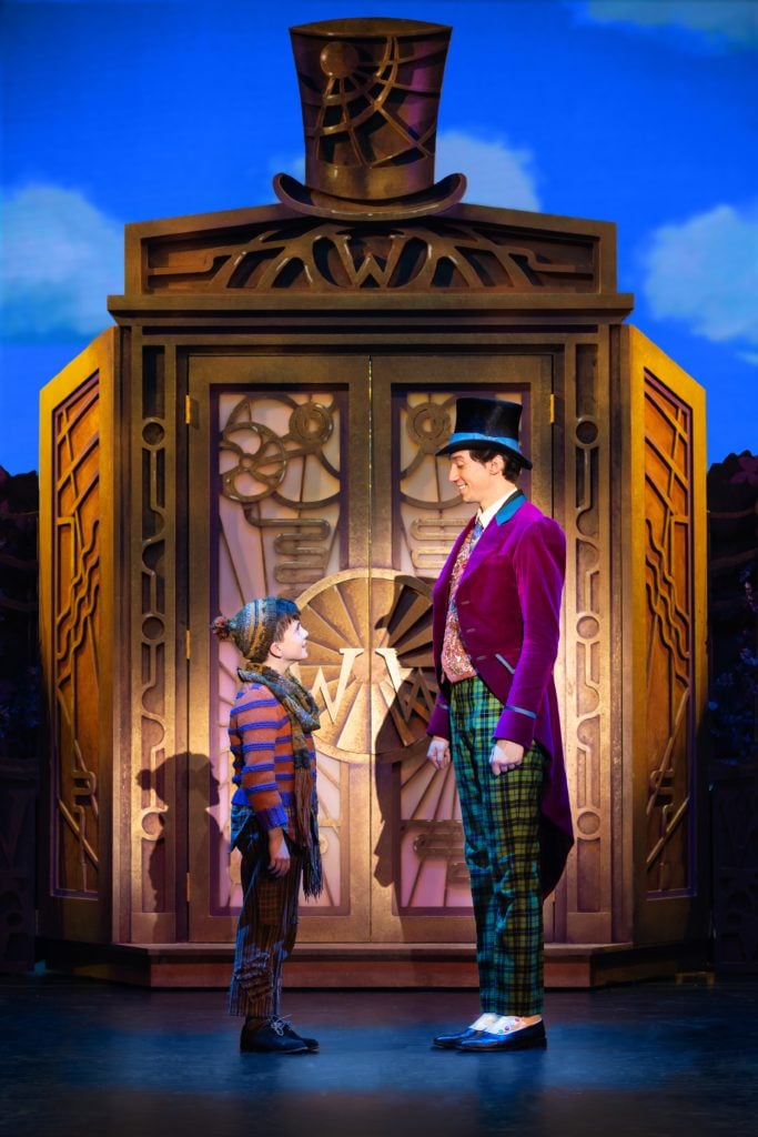 Ryan Umbarila as Charlie Bucket and Cody Garcia as Willy Wonka in Roald Dahl’s CHARLIE AND THE CHOCOLATE FACTORY presented by Broadway On Tour December 28, 2021 – January 2, 2022 at the SAFE Credit Union Performing Arts Center. Photo by Jeremy Daniel.