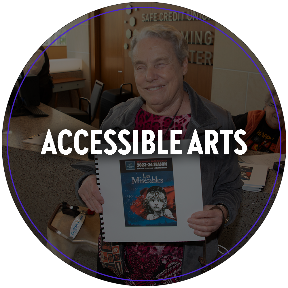 A circular image of a vision impaired person with a large smile holding a braille program for Les Miserables. Text in the center of the image reads "Accessible Arts". 

You can click the image to redirect to the Accessible Arts web page. 